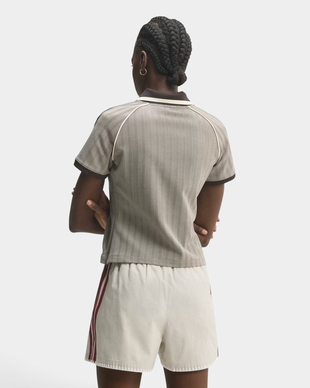 Model wearing a Lockwood Avenue adidas slim fit polo shirt with a grey herringbone pattern and brown collar
