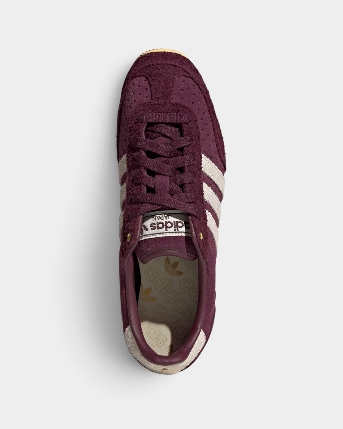 Lockwood Avenue adidas Japan maroon suede sneakers with cream white stripes and gold metallic accents, top view.