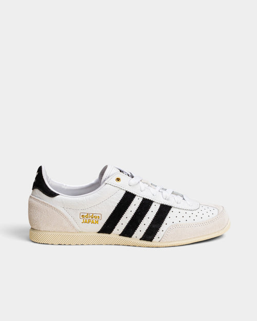 Lockwood Avenue adidas Japan women's trainer in white perforated leather with black stripes and gold logo detailing.