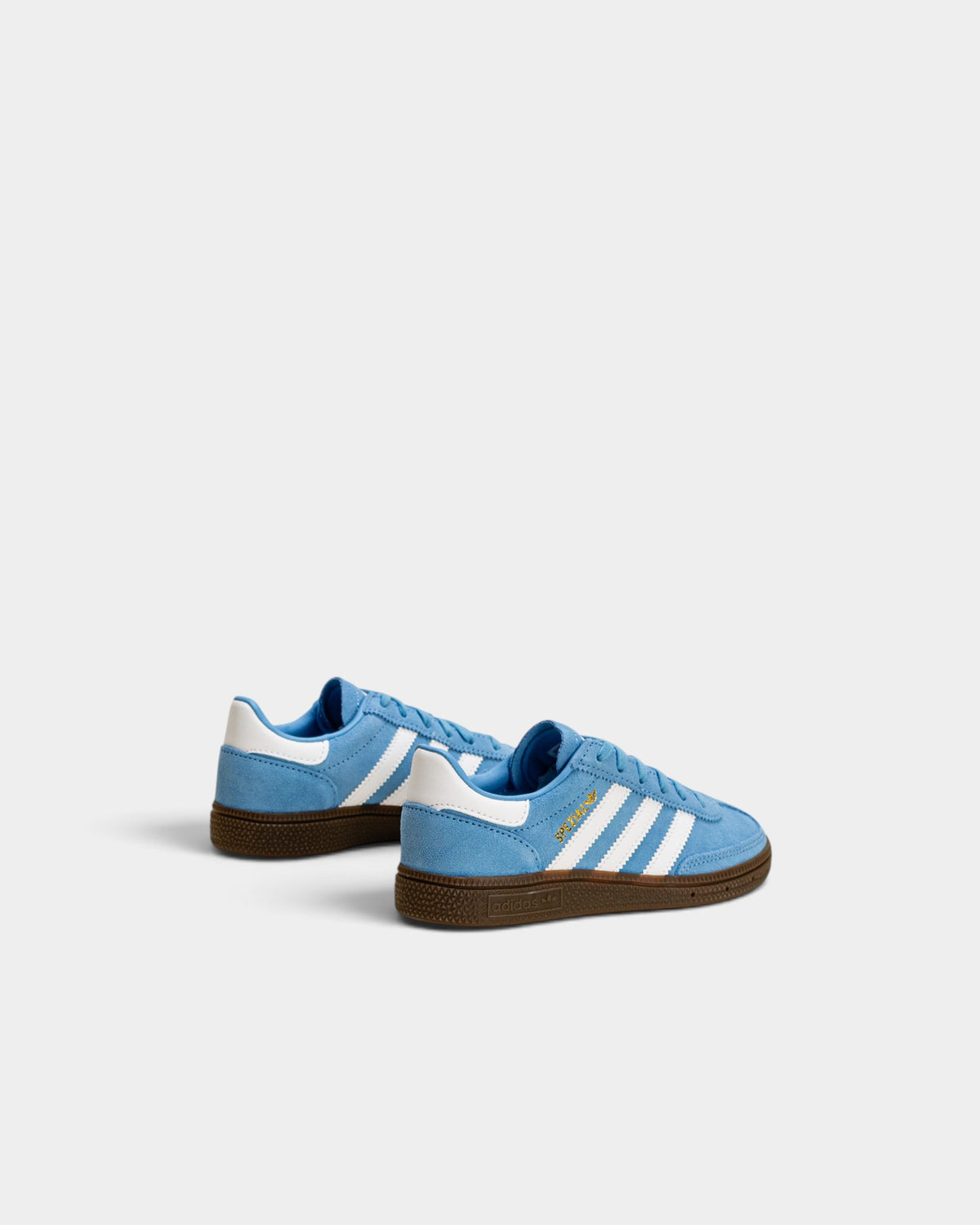 Lockwood Avenue adidas kids light blue suede Handball Spezial sneakers with white stripes and gum rubber soles.