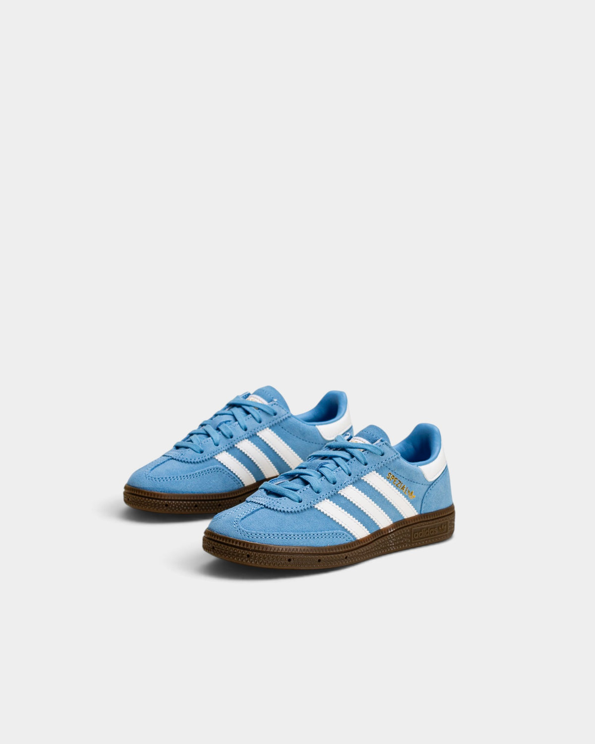 Lockwood Avenue adidas Kids Handball Spezial shoes in light blue suede with white stripes and gum rubber sole.