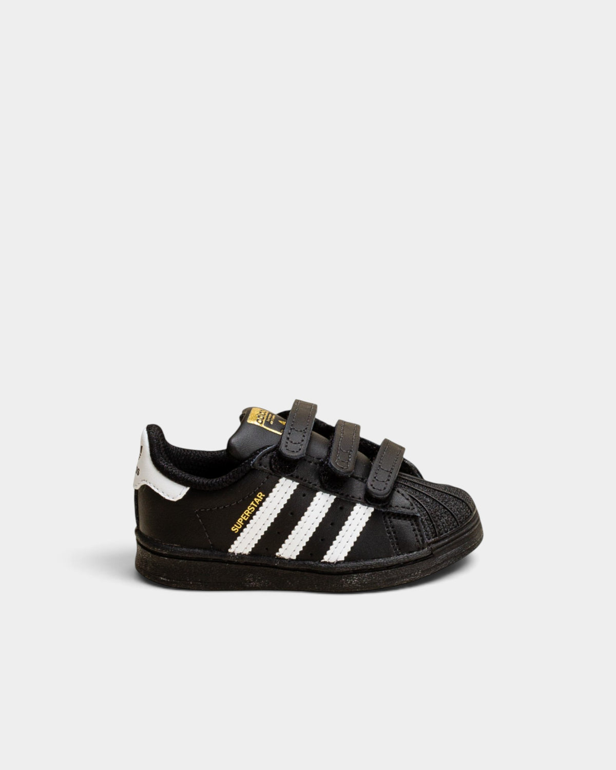 Lockwood Avenue adidas Kids Superstar shoes in black with white stripes, rubber shell toe, and hook-and-loop straps.