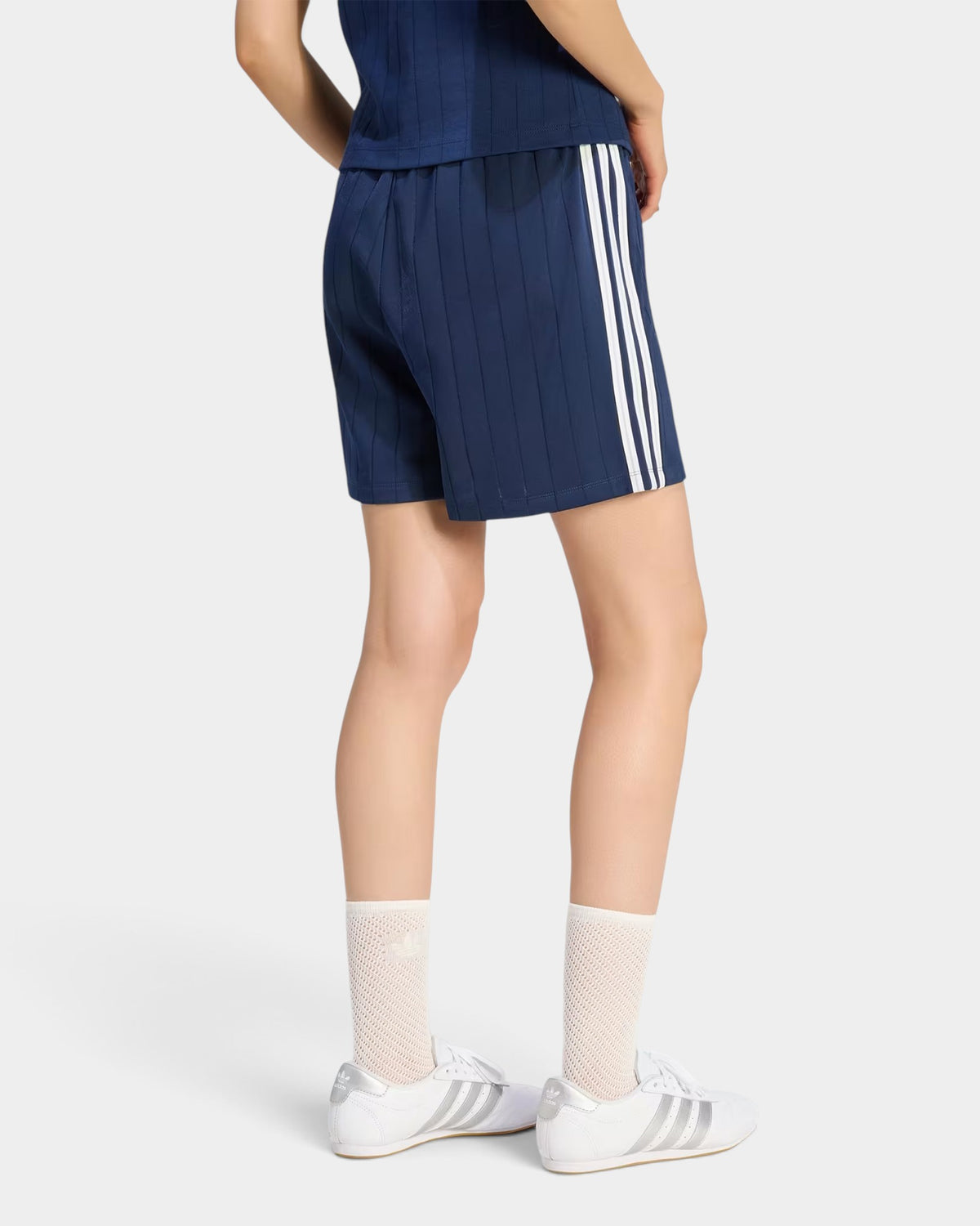 Lockwood Avenue adidas pinstripe night indigo tricot shorts with white side stripes worn by a model from behind