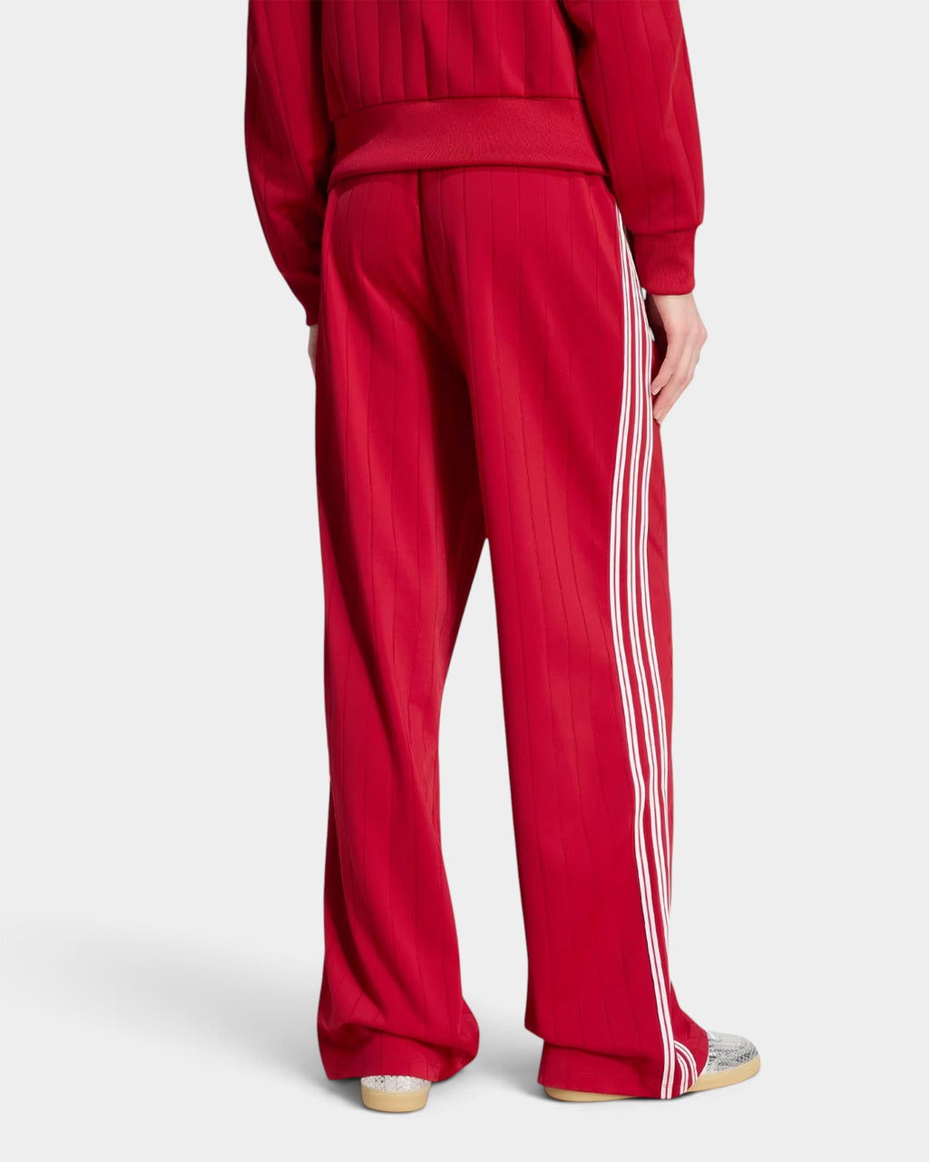 Lockwood Avenue adidas Firebird loose red track pants with white 3-Stripes, back view showing ankle zips