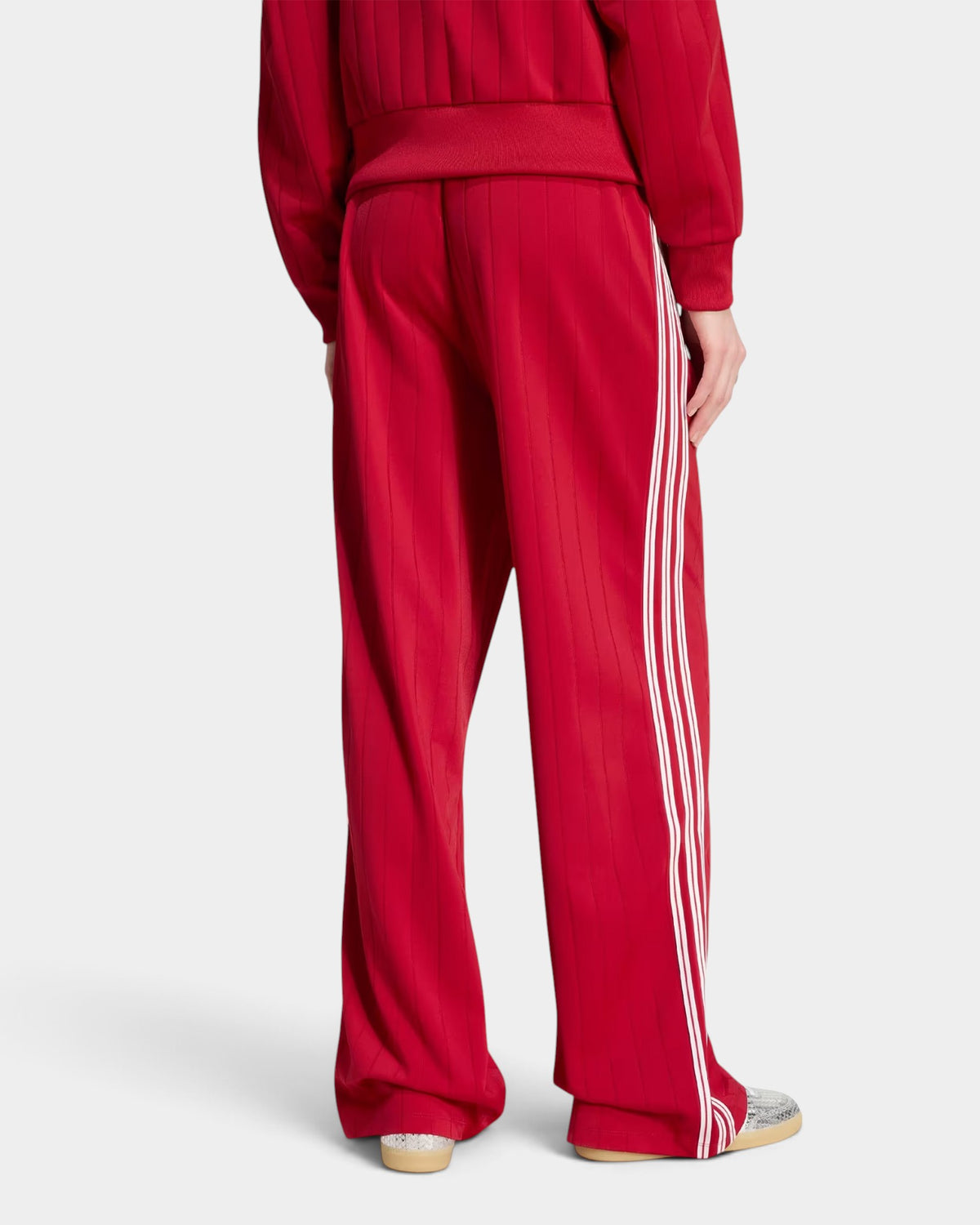 Lockwood Avenue adidas Firebird loose red track pants with white 3-Stripes, back view showing ankle zips