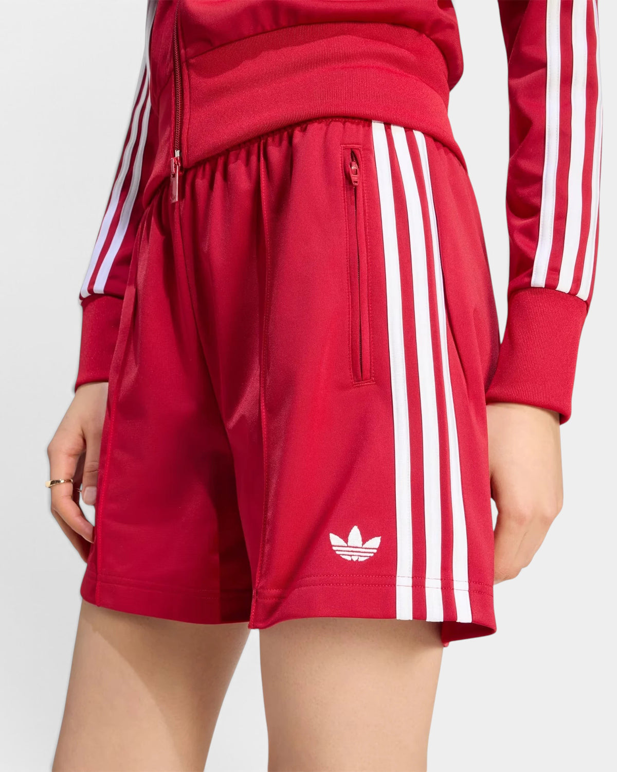 Lockwood Avenue adidas Firebird red tricot shorts with white 3-Stripes and trefoil logo on a model