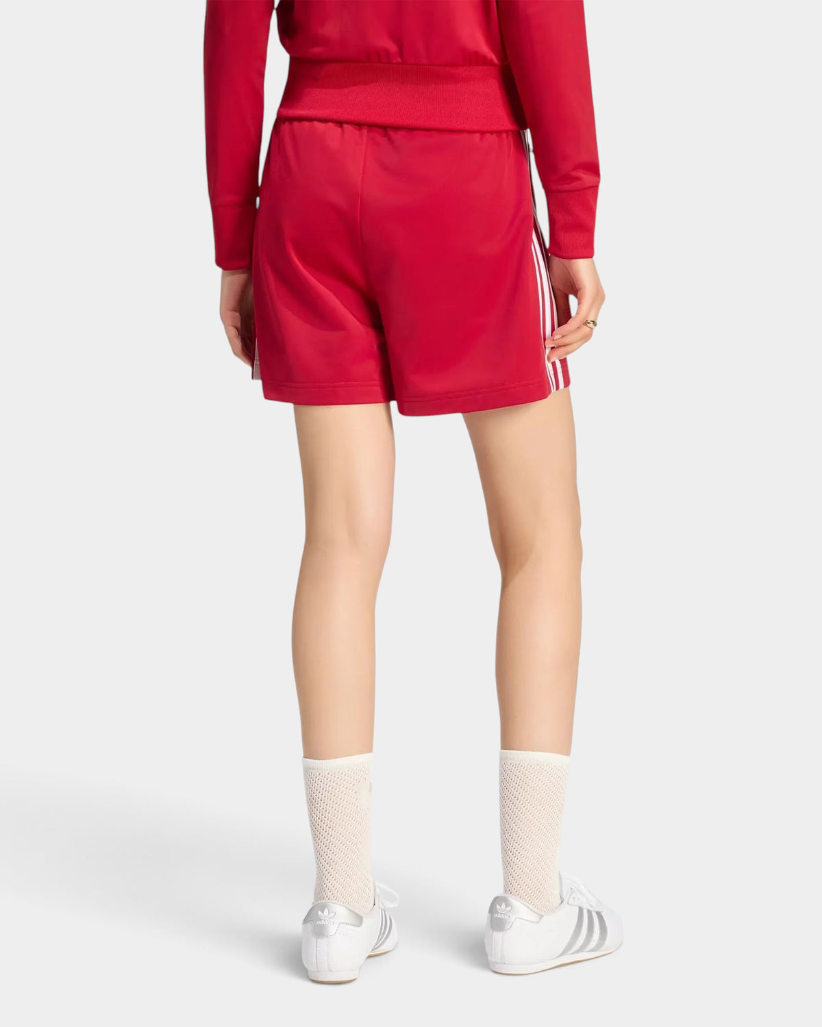 Lockwood Avenue adidas Firebird red tricot shorts with white 3-Stripes, back view on a model