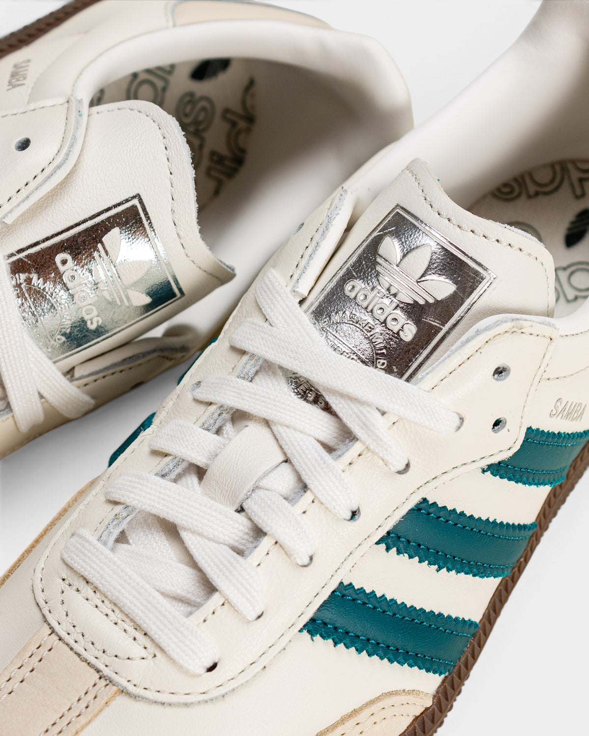 Lockwood Avenue adidas Samba OG shoes in cloud white leather with legacy teal stripes and metallic silver tongue tag.
