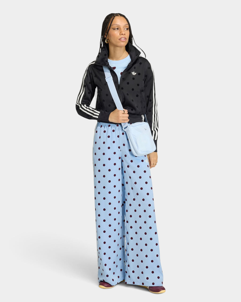 Lockwood Avenue model wearing adidas satin wide leg pants in light blue with dark polka dots and a drawstring waist