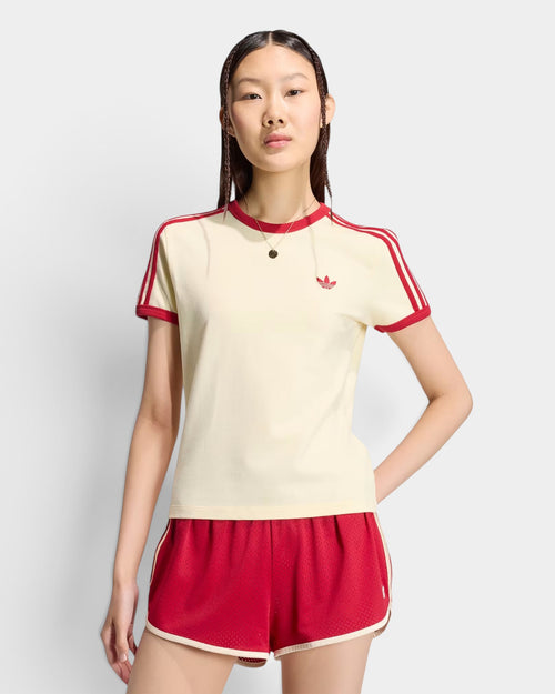 Lockwood Avenue model wearing an adidas cream slim-fit t-shirt with red 3-stripes and a round neck