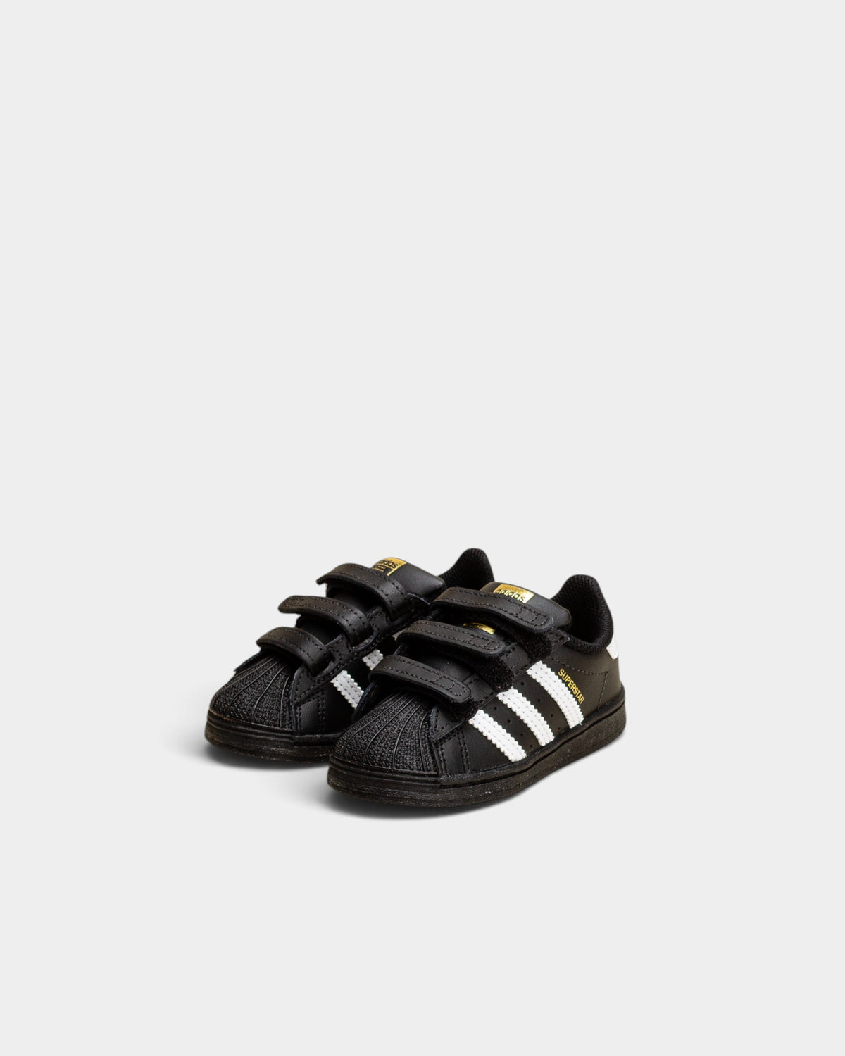 Lockwood Avenue adidas Kids Superstar shoes in black with white stripes and a signature rubber shell toe.