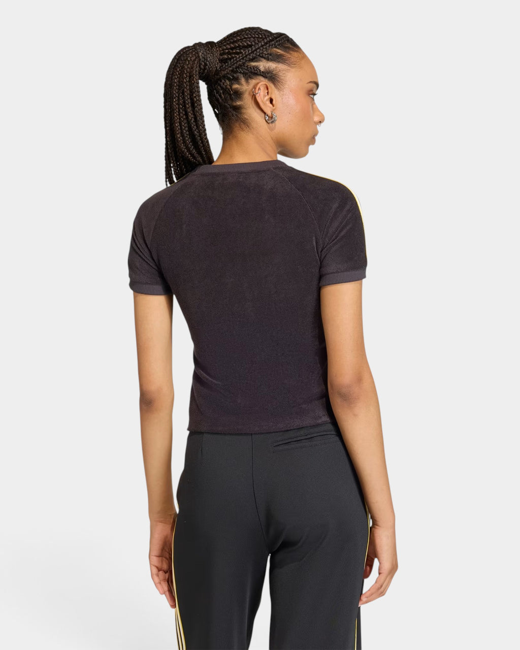 Lockwood Avenue model wearing a slim-fit black adidas terry towel t-shirt with yellow sleeve stripes, back view.