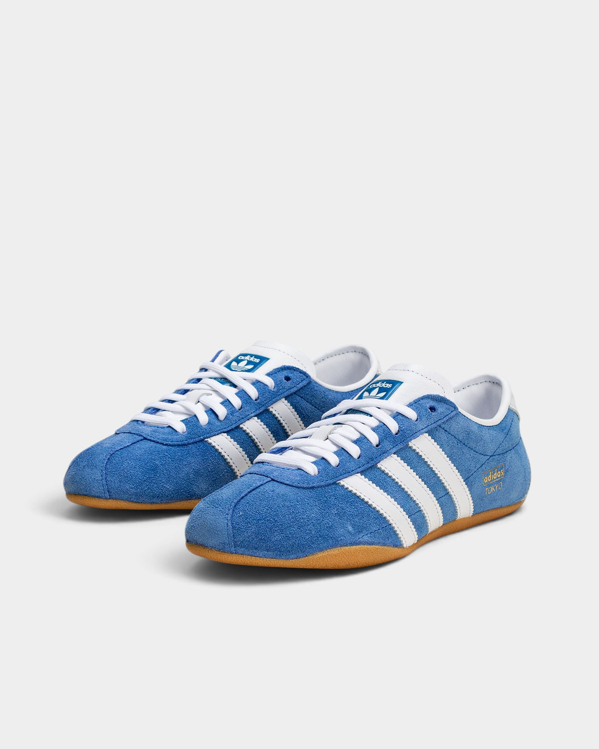 Lockwood Avenue adidas Tokyo retro sneakers in blue suede with white stripes, gold-foil branding, and gum rubber sole.