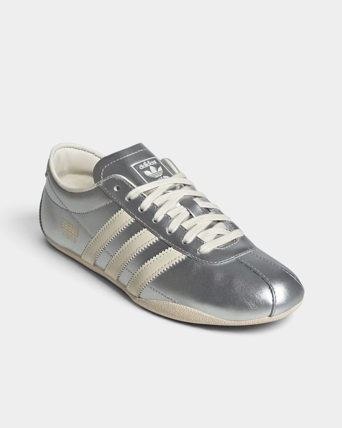 Lockwood Avenue adidas Tokyo women's sneakers in silver metallic nylon and suede with cream white stripes.