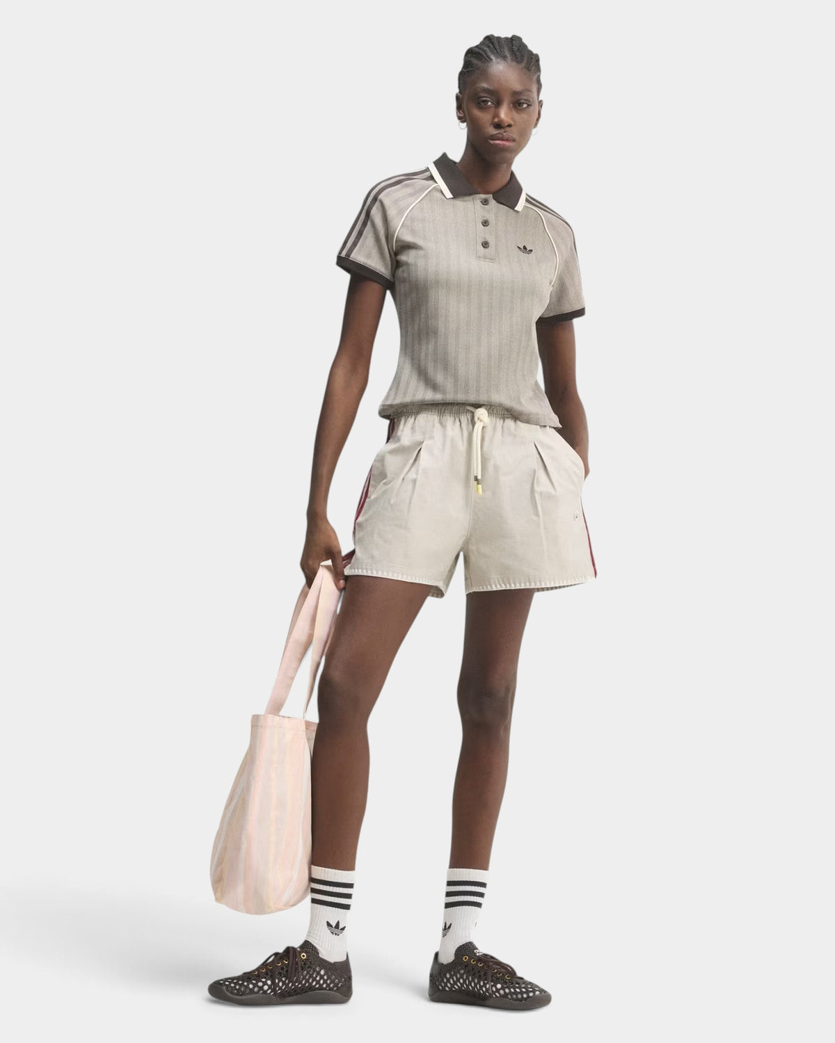 Lockwood Avenue model wearing an adidas slim fit grey tweed polo shirt with a herringbone pattern and polo collar.
