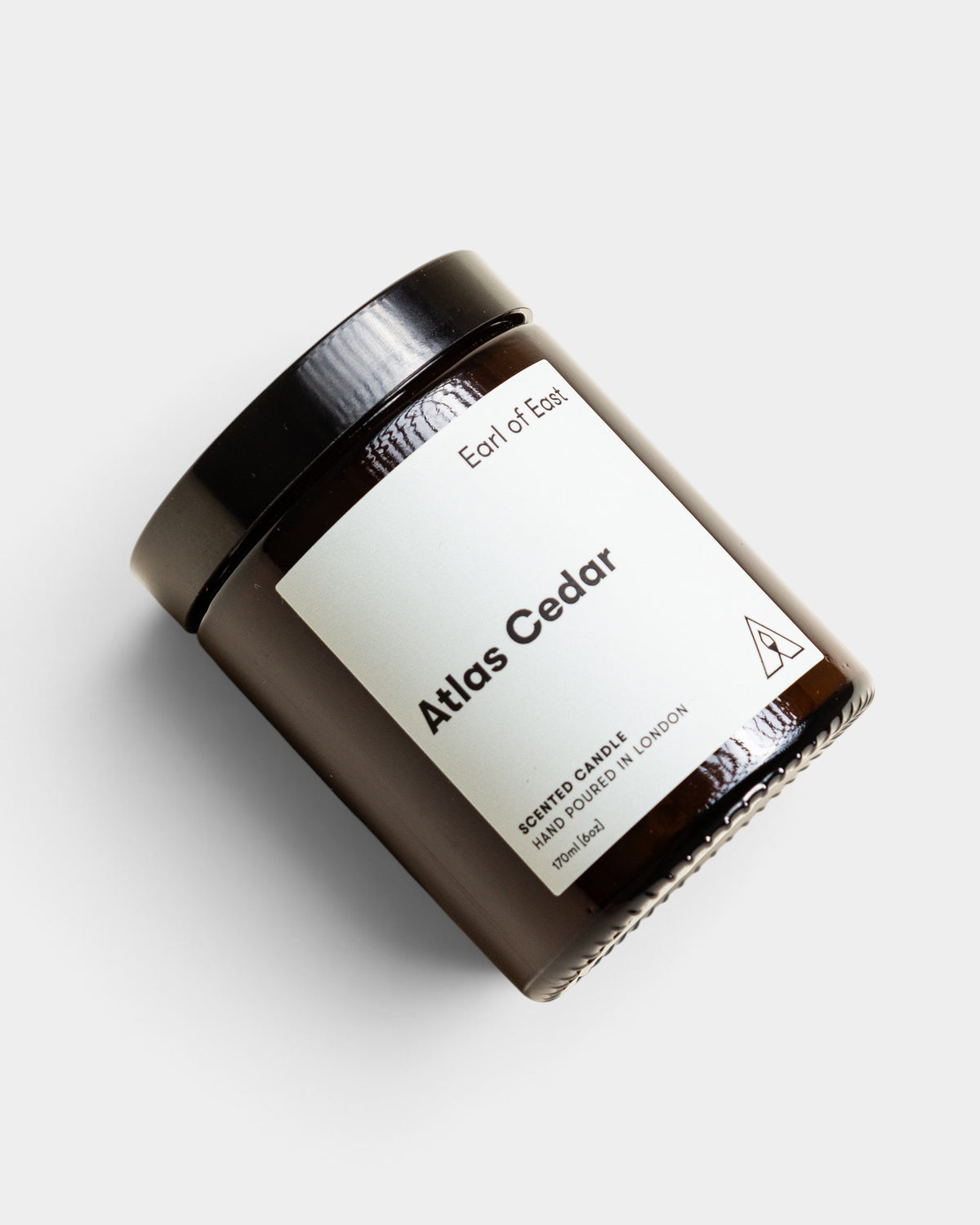Lockwood Avenue Earl of East Atlas Cedar soy wax candle in a recyclable amber glass jar with a black lid