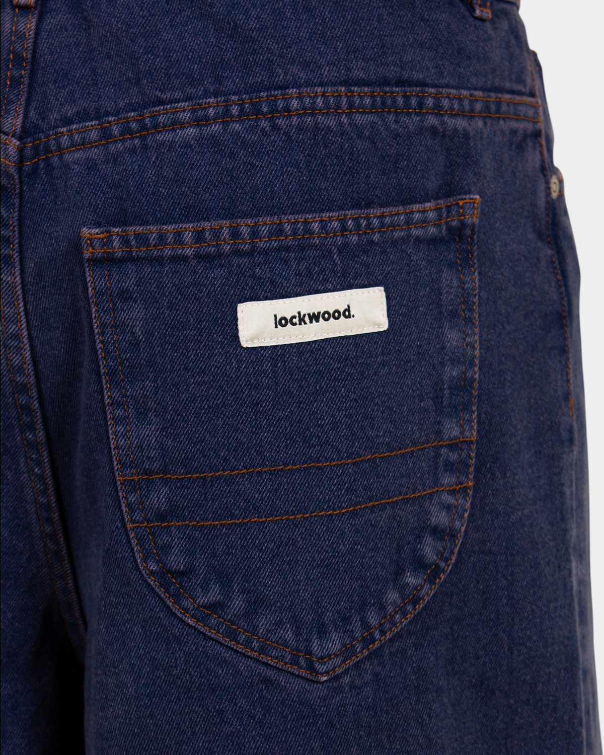 Lockwood Avenue baggy denim shorts in overdye blue cotton with angular back pocket and branded label detail