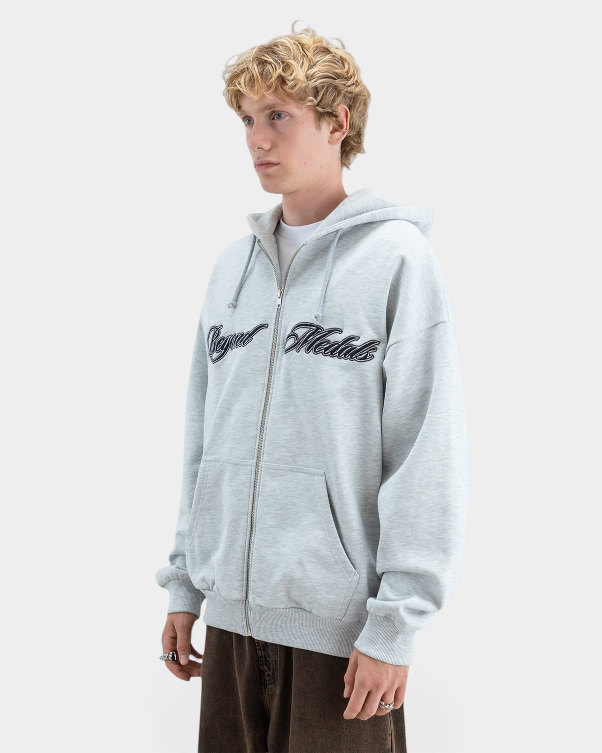 Lockwood Avenue Beyond Medals grey zip hoodie with black embroidered script logo on chest, worn by a male model.