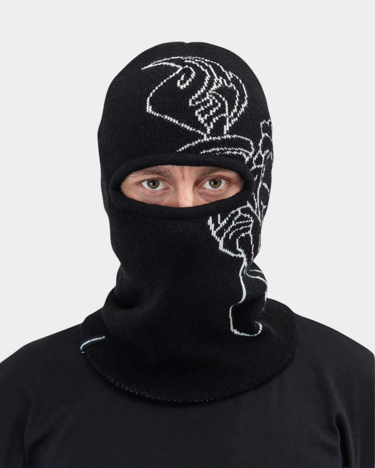 Lockwood Avenue Beyond Medals black acrylic balaclava with white jacquard angel artwork and single eye opening