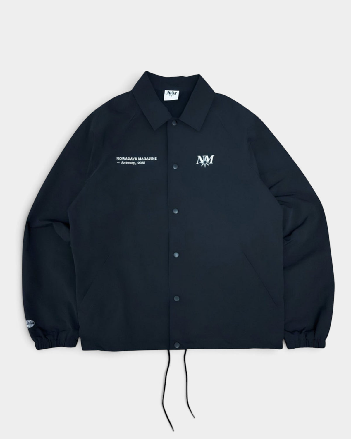 Lockwood Avenue black lightweight polyester snap-front coach jacket with Nowadays Magazine chest branding