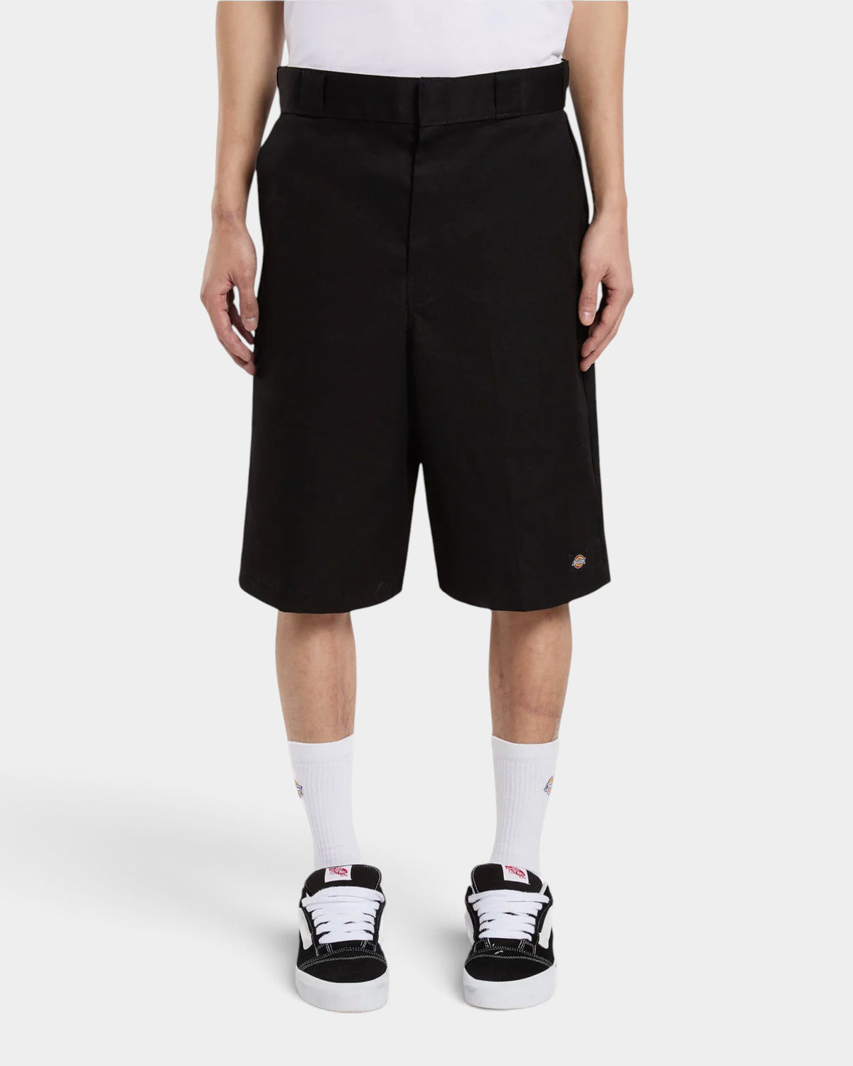 Lockwood Avenue model wearing black Dickies 13 inch loose fit poly-cotton work shorts with a side utility pocket.
