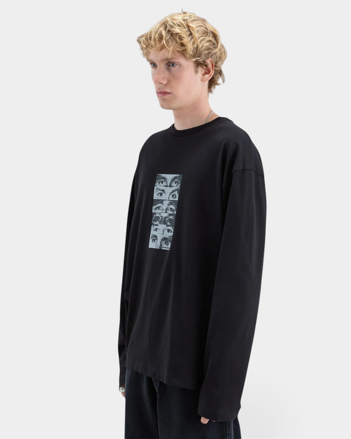 Lockwood Avenue black long-sleeve cotton t-shirt with a halftone eye graphic print on the chest, worn by a model.