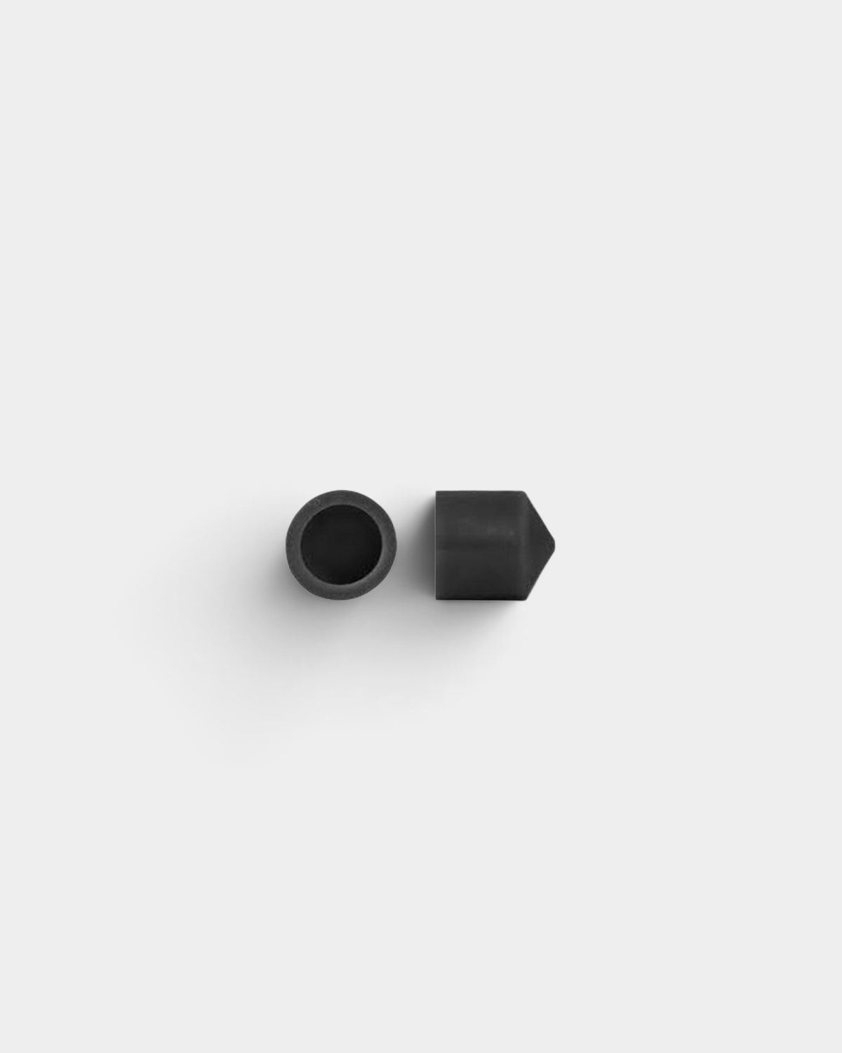 Lockwood Avenue black urethane pivot cup for skateboard trucks, shown from top and side views.