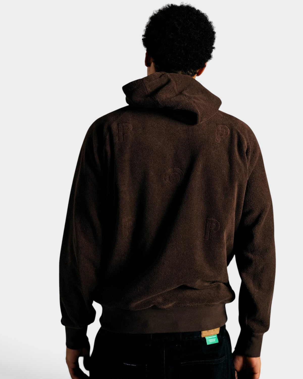Lockwood Avenue brown cotton terry hooded sweatshirt with embroidered back logo worn by a man from behind