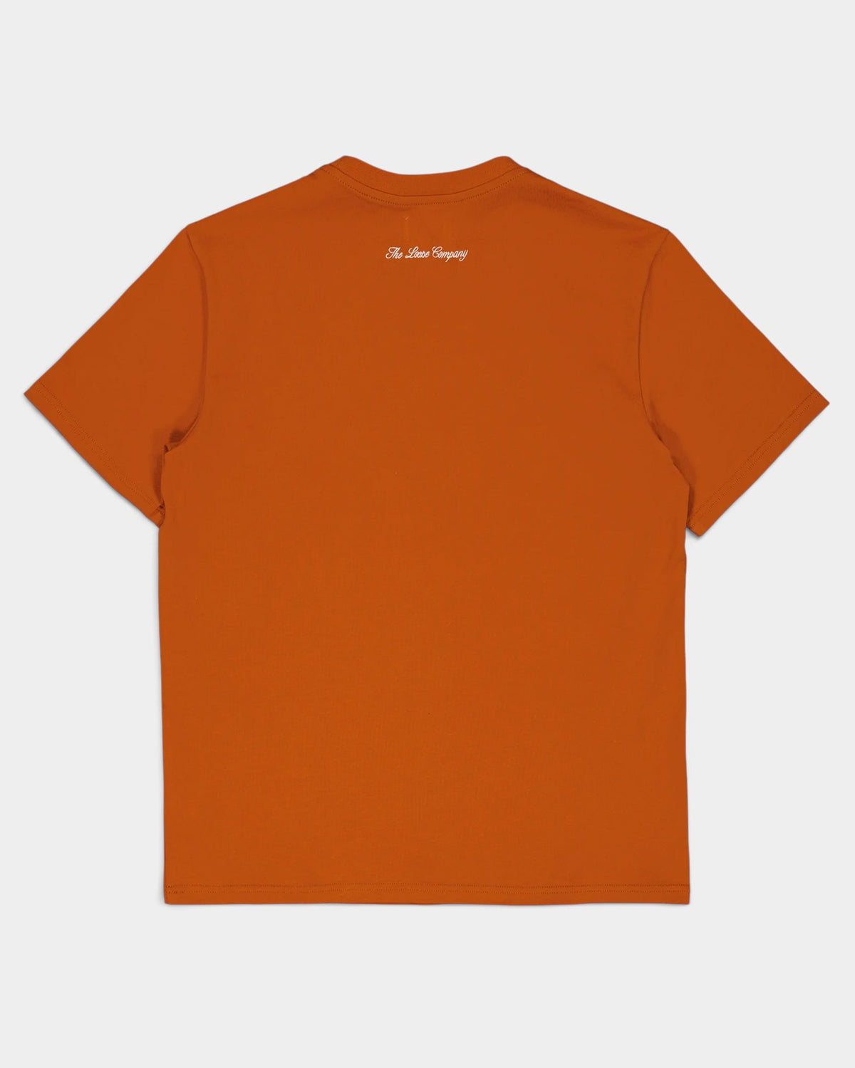 Back view of a burnt orange Lockwood Avenue The Loose Company cotton t-shirt with white script logo at the collar.
