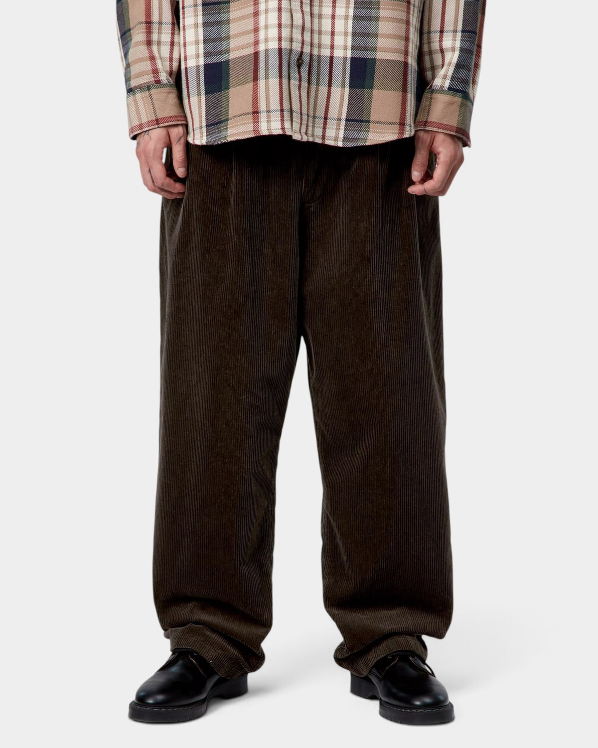 Lockwood Avenue Carhartt Evan dark brown corduroy trousers featuring a loose tapered fit and double front pleats.
