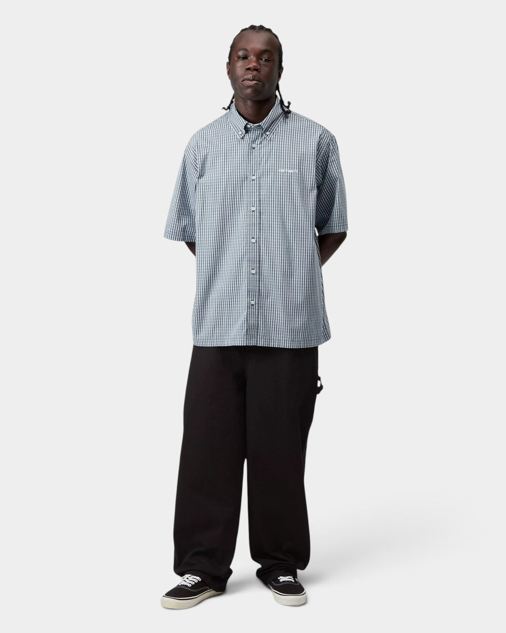 Model wearing a Lockwood Avenue Carhartt Groff short-sleeve blue check cotton poplin shirt with a button-down collar.