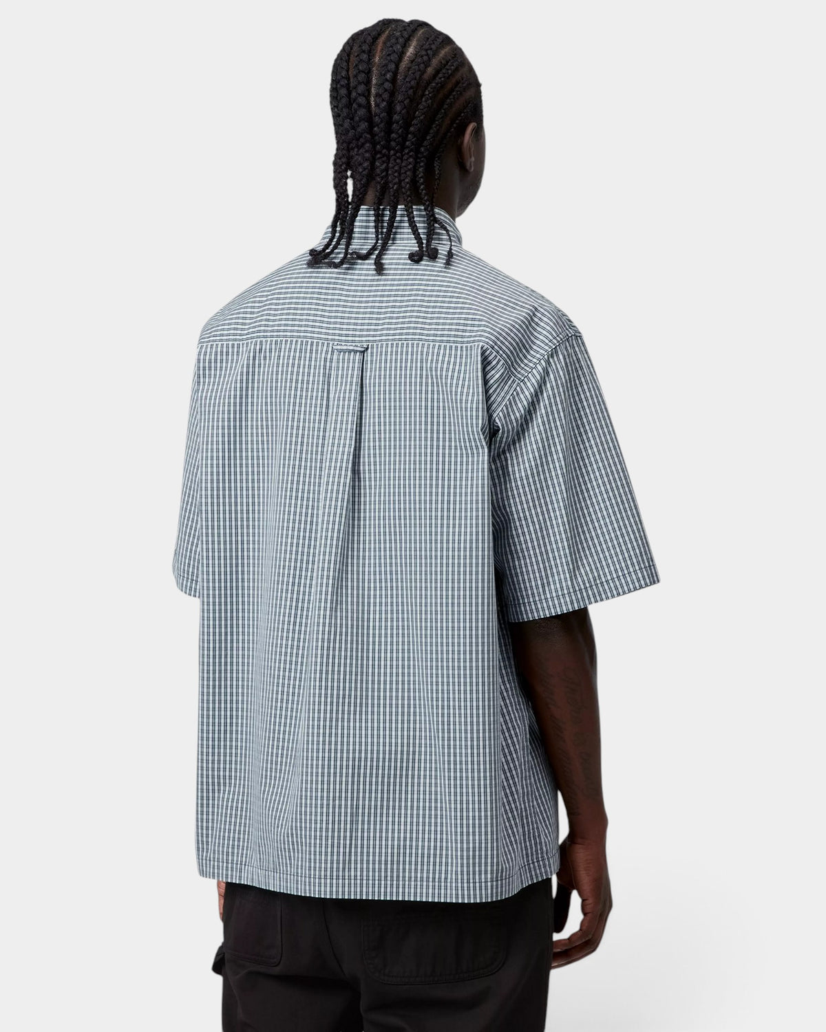Back view of a model wearing a Lockwood Avenue Carhartt Groff short-sleeve shirt in blue check cotton poplin.