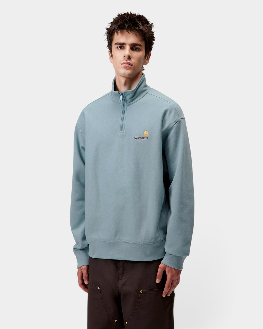 Lockwood Avenue model wearing a light blue Carhartt American Script half-zip sweatshirt with embroidered logo