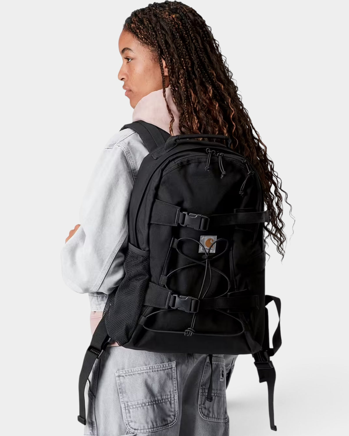 Lockwood Avenue Carhartt Kickflip black skate backpack with front board straps worn by a person