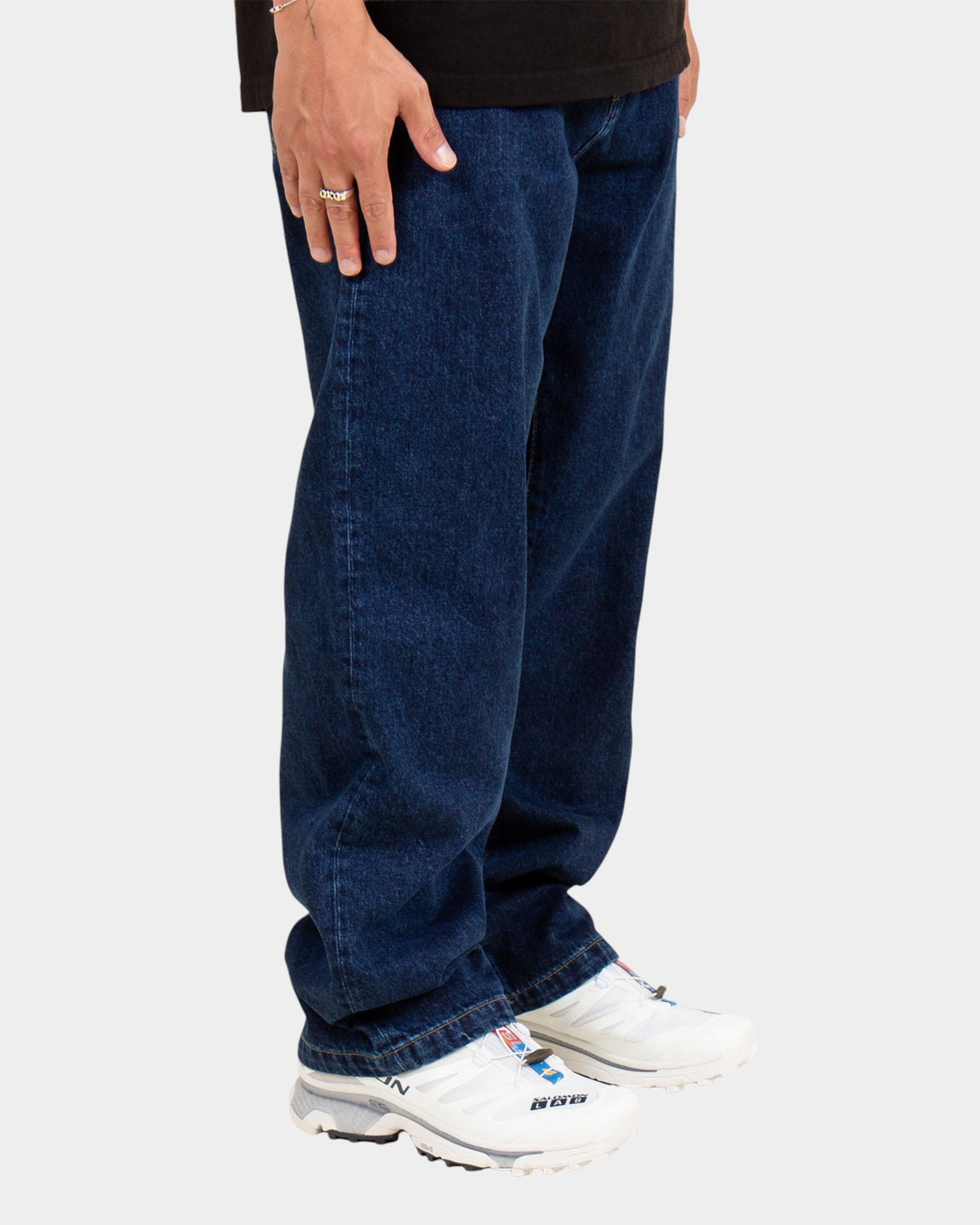 Lockwood Avenue Carhartt Landon loose tapered blue denim pants worn by a model with white sneakers