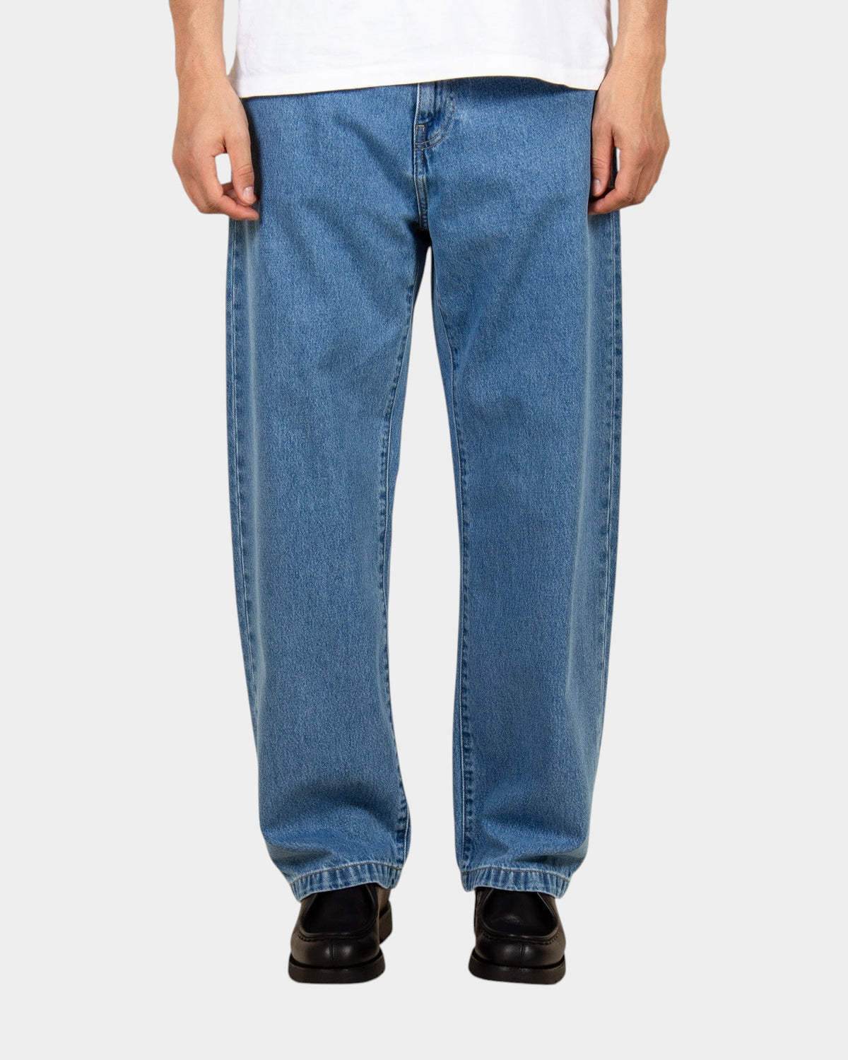 Lockwood Avenue Carhartt Landon stone-washed blue denim pants in a loose tapered fit on a model