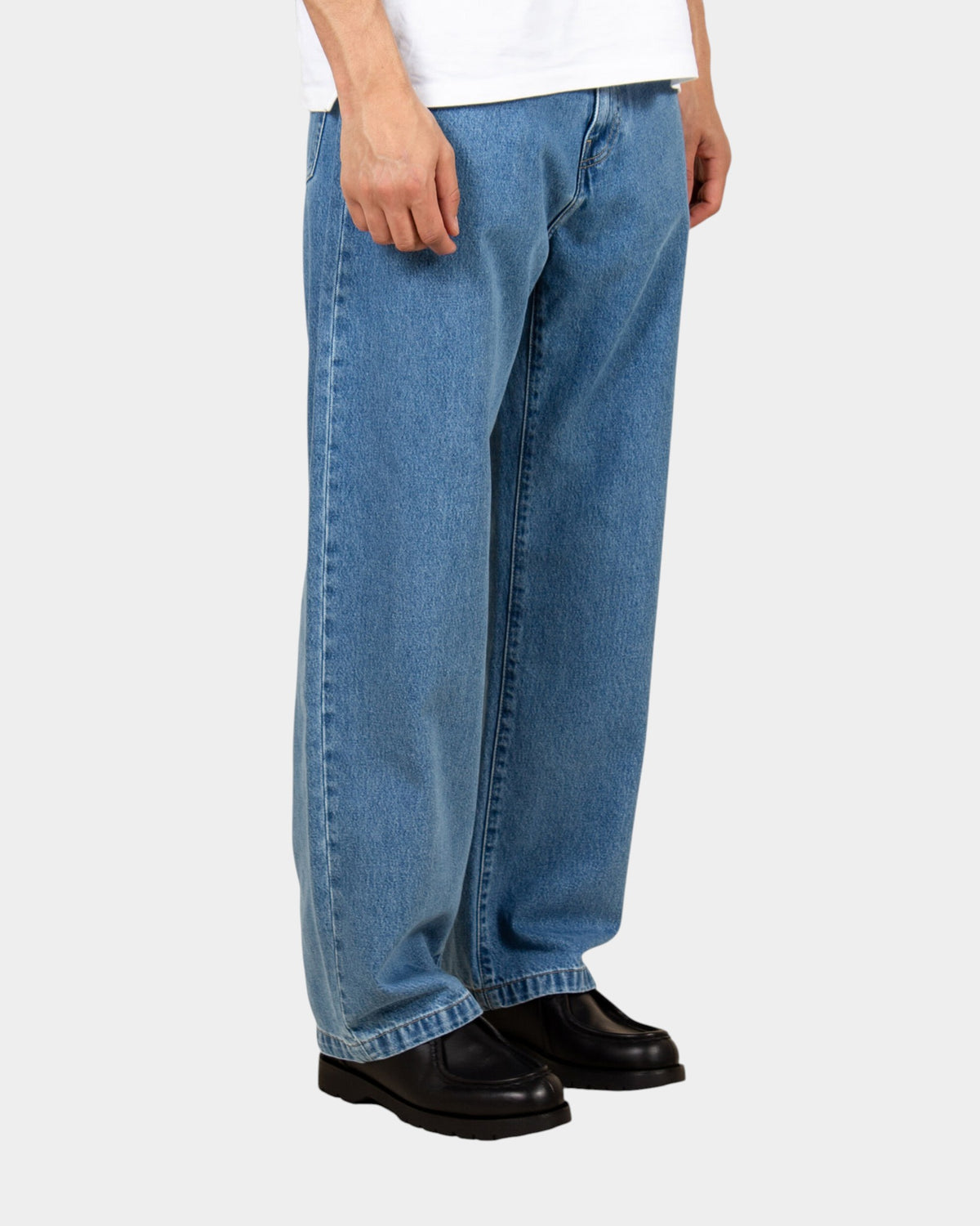 Lockwood Avenue Carhartt Landon stone-washed blue denim pants in a loose tapered fit worn by a model