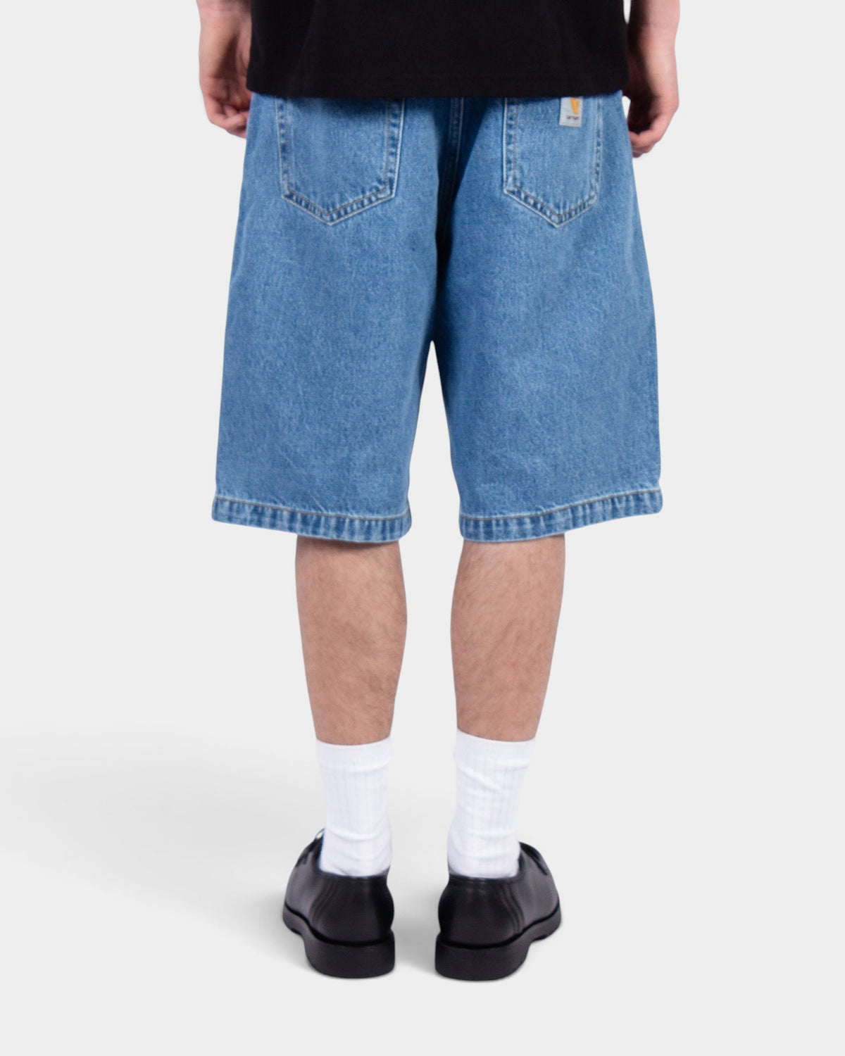 Lockwood Avenue Carhartt Landon denim shorts in faded mid-blue with a loose fit and back square label, rear view.