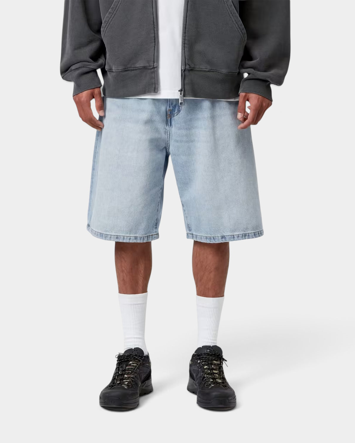 Model wearing Lockwood Avenue Carhartt Landon loose fit light blue denim shorts with a zip-fly and five-pocket style.