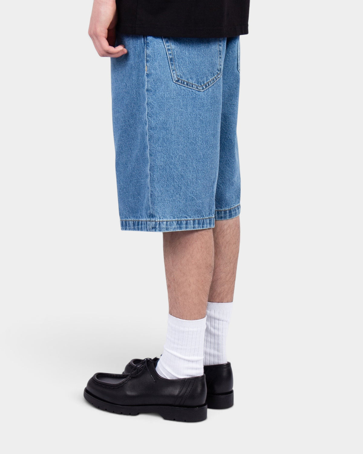 Lockwood Avenue Carhartt Landon stone-washed mid-blue denim shorts worn by a model in a side profile view.