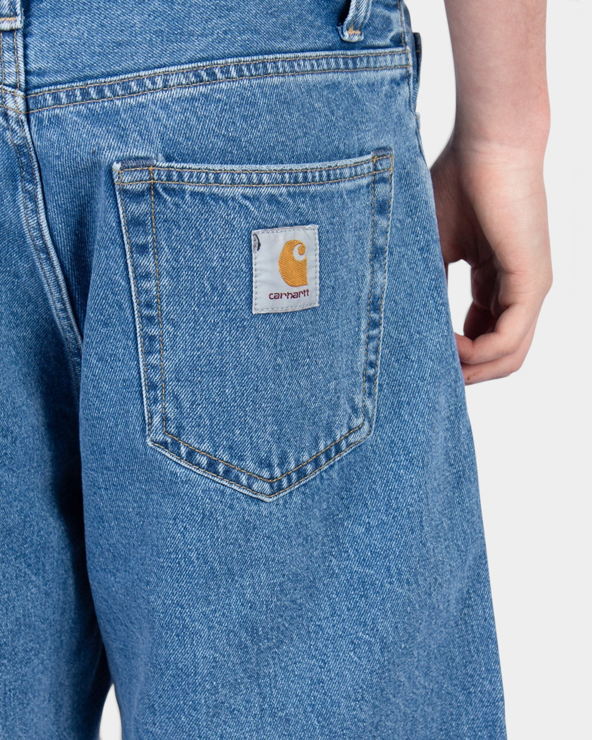 Lockwood Avenue Carhartt Landon denim shorts in faded mid-blue with a woven square logo patch on the back pocket.