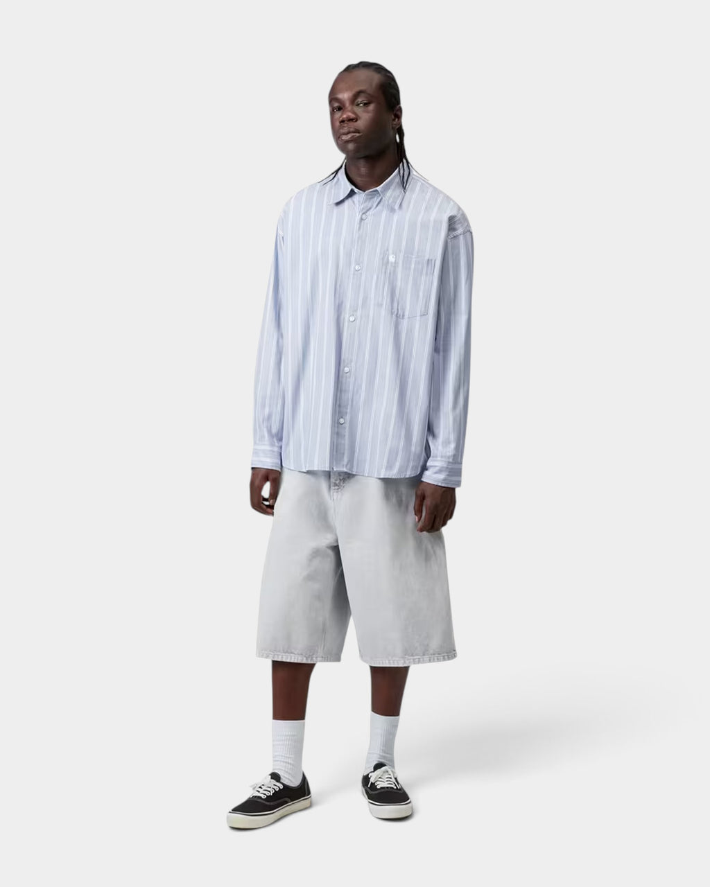 Lockwood Avenue Carhartt long-sleeve striped dobby cotton shirt in light blue worn by a model with denim shorts.