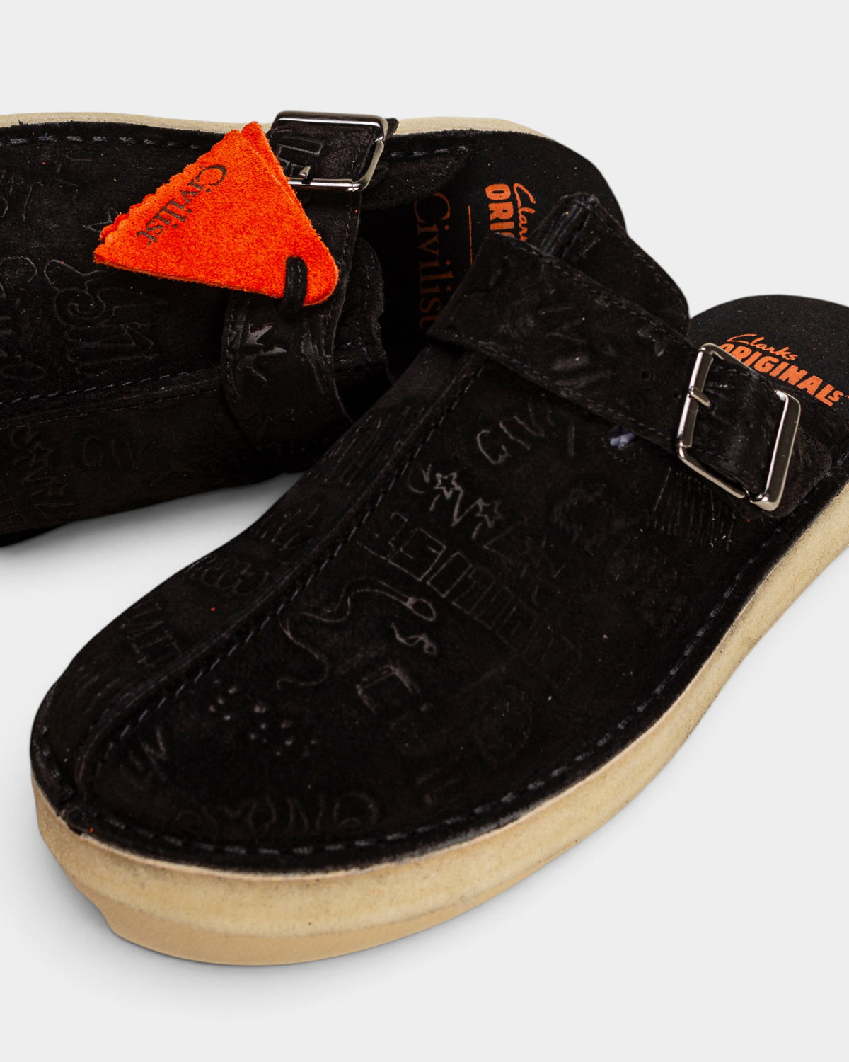 Lockwood Avenue Clarks Originals x Civilist black suede Trek Mule shoes with debossed graphics and orange tassel fob
