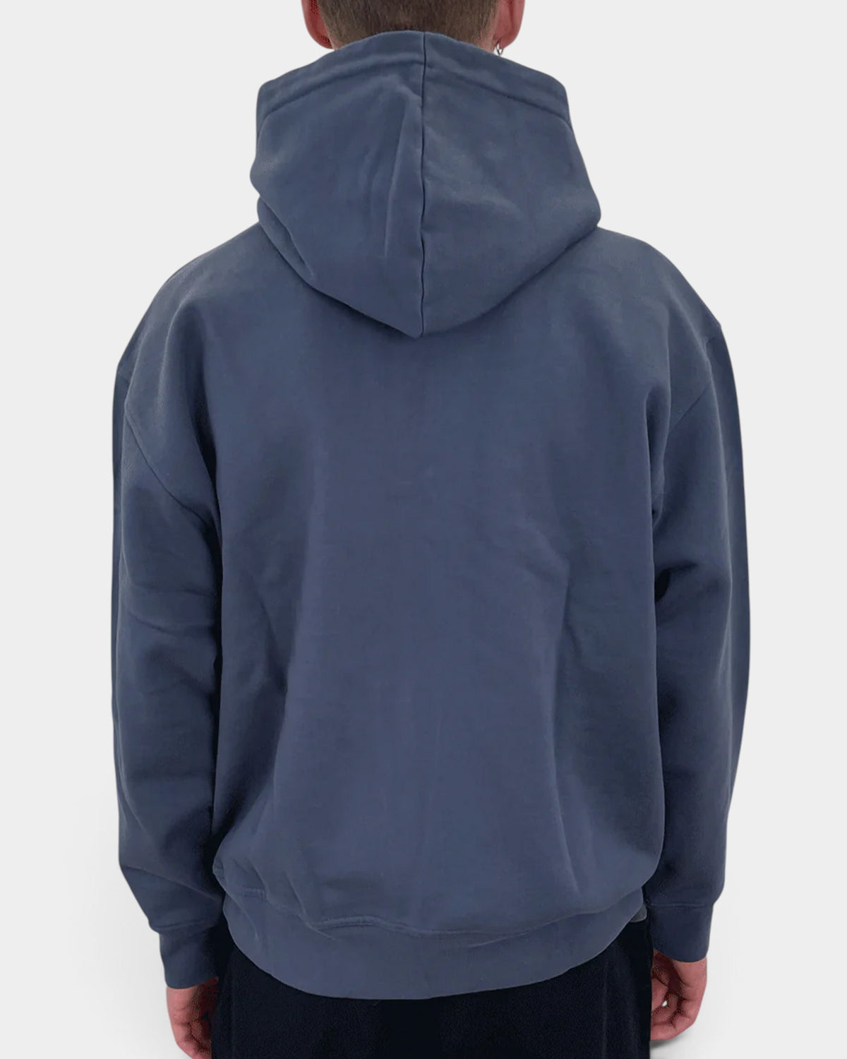 Back view of a person wearing a navy blue Lockwood Avenue Dancer organic cotton zip hoodie with a hood up.