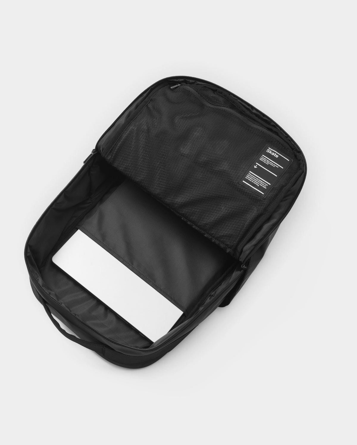Lockwood Avenue DB Journey 20L daypack interior showing a laptop sleeve and mesh storage pocket on a white background