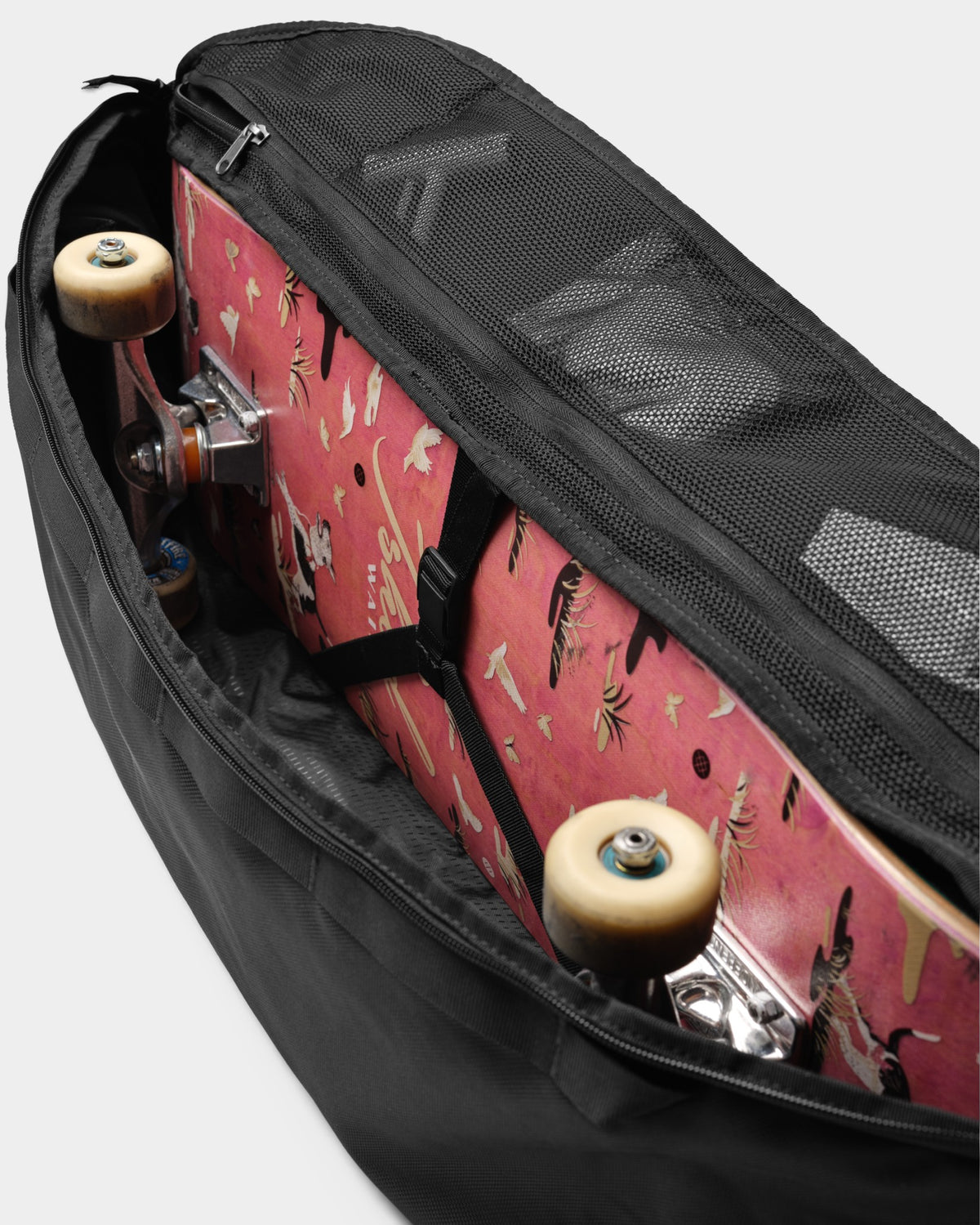 Lockwood Avenue DB Journey Skate 32L Carrier in black, showing a skateboard stored inside the main compartment.