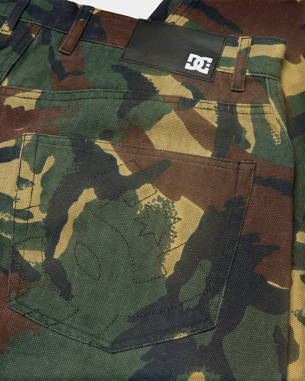 Lockwood Avenue DC Barrel canvas pants in green camouflage print with a black leather brand patch on the back pocket