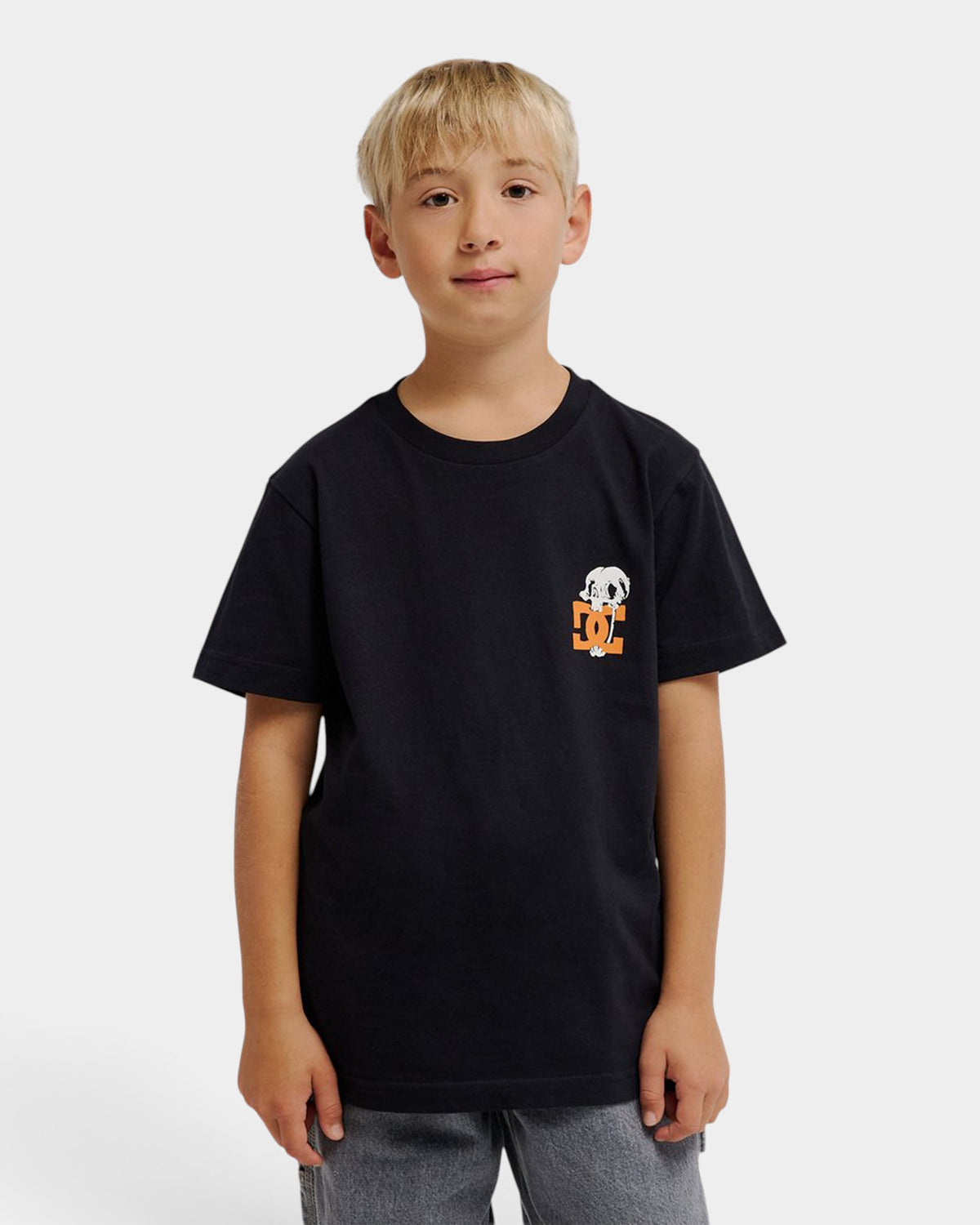 Young boy wearing a black Lockwood Avenue DC Cartoon Jaws youth t-shirt with a small graphic on the chest.