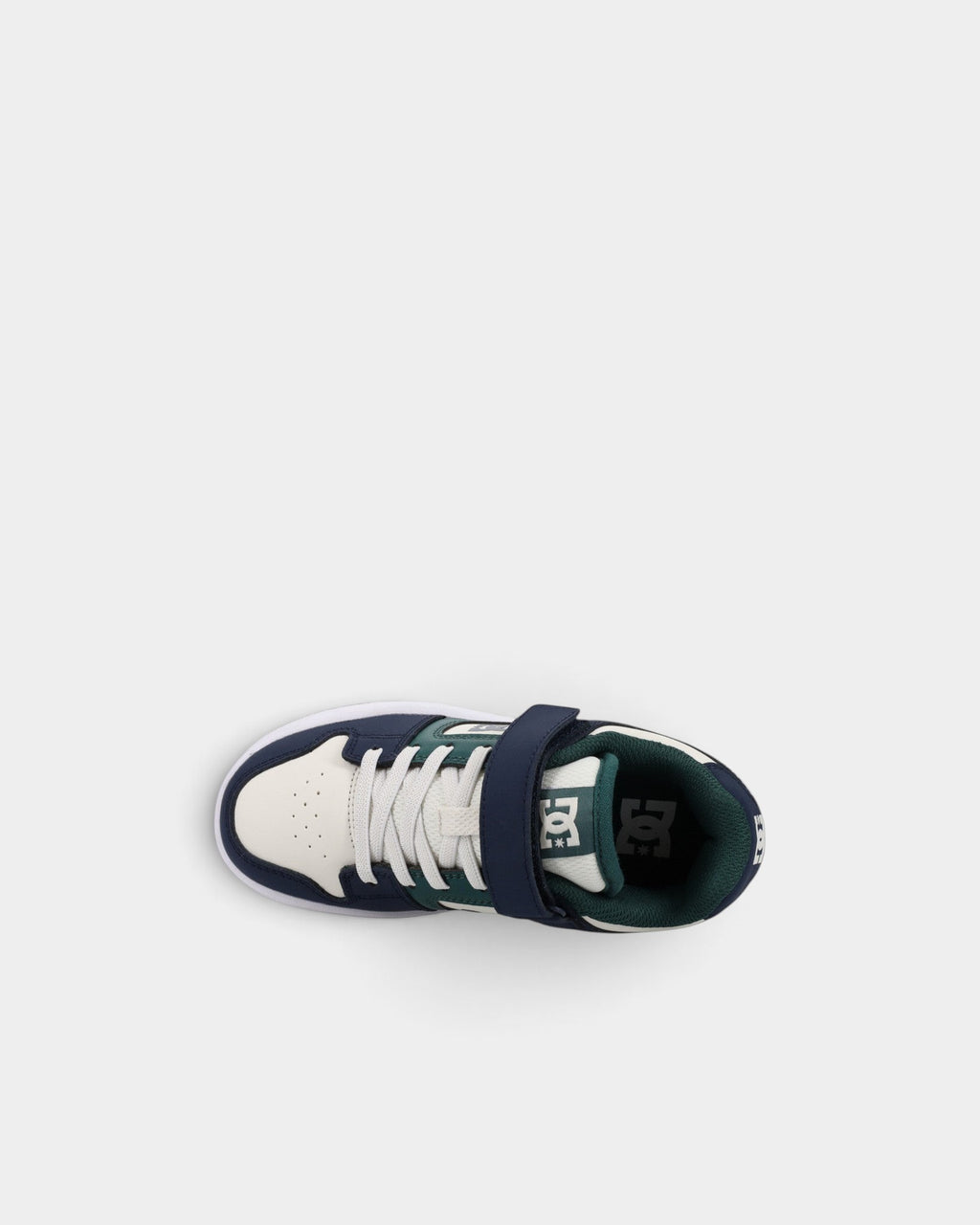 Lockwood Avenue DC Manteca 4 kids skate shoes in navy, white, and green with velcro strap and elastic laces