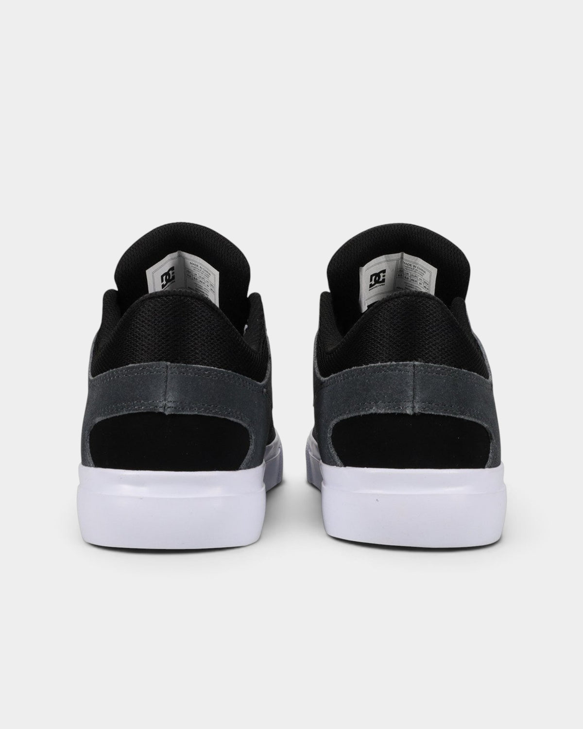 Lockwood Avenue DC Onyx S skate shoes in black with white vulcanized soles, shown from the back view.